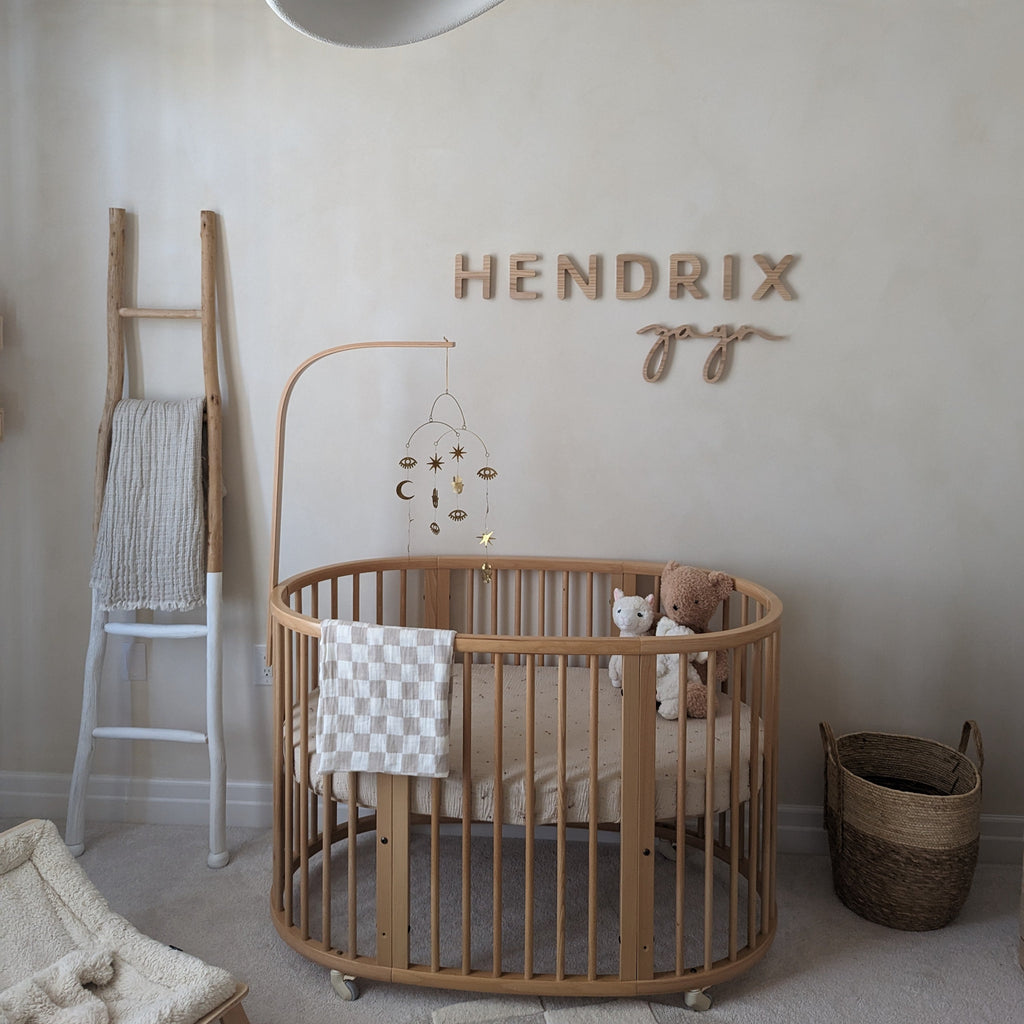 wooden name sign for a boy with neutral wooden accents