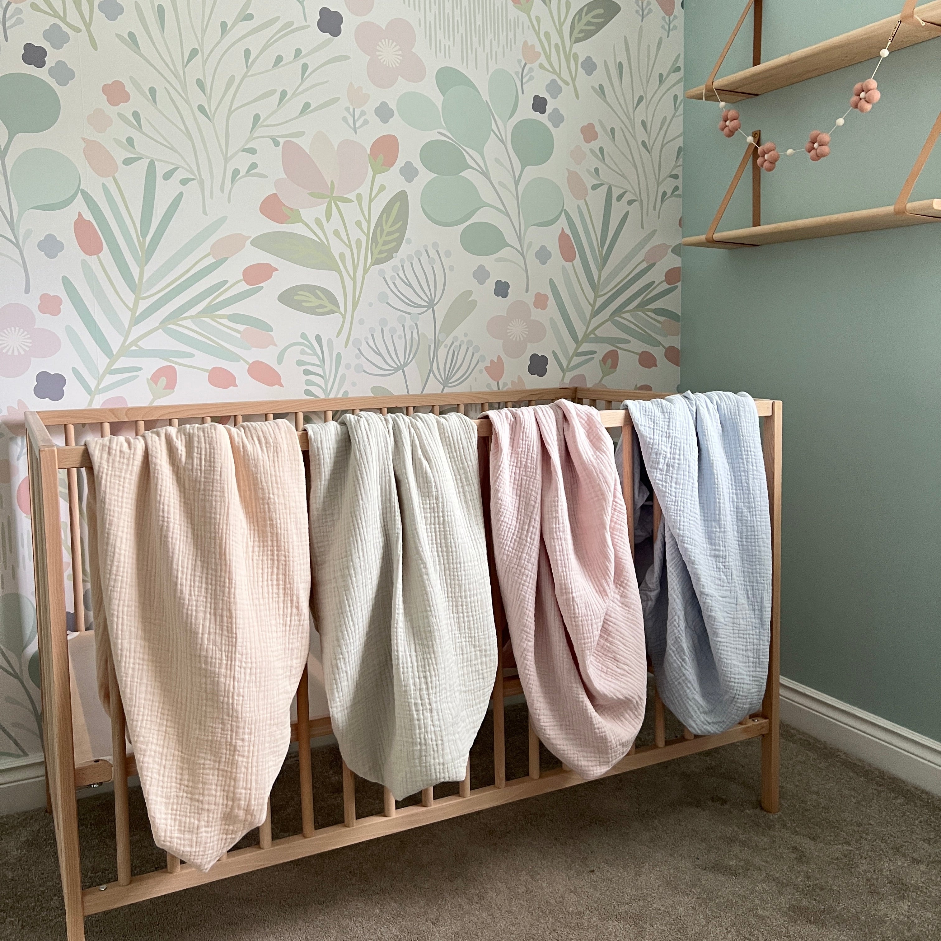 Wooden ladder with folded clothes on a floral rug