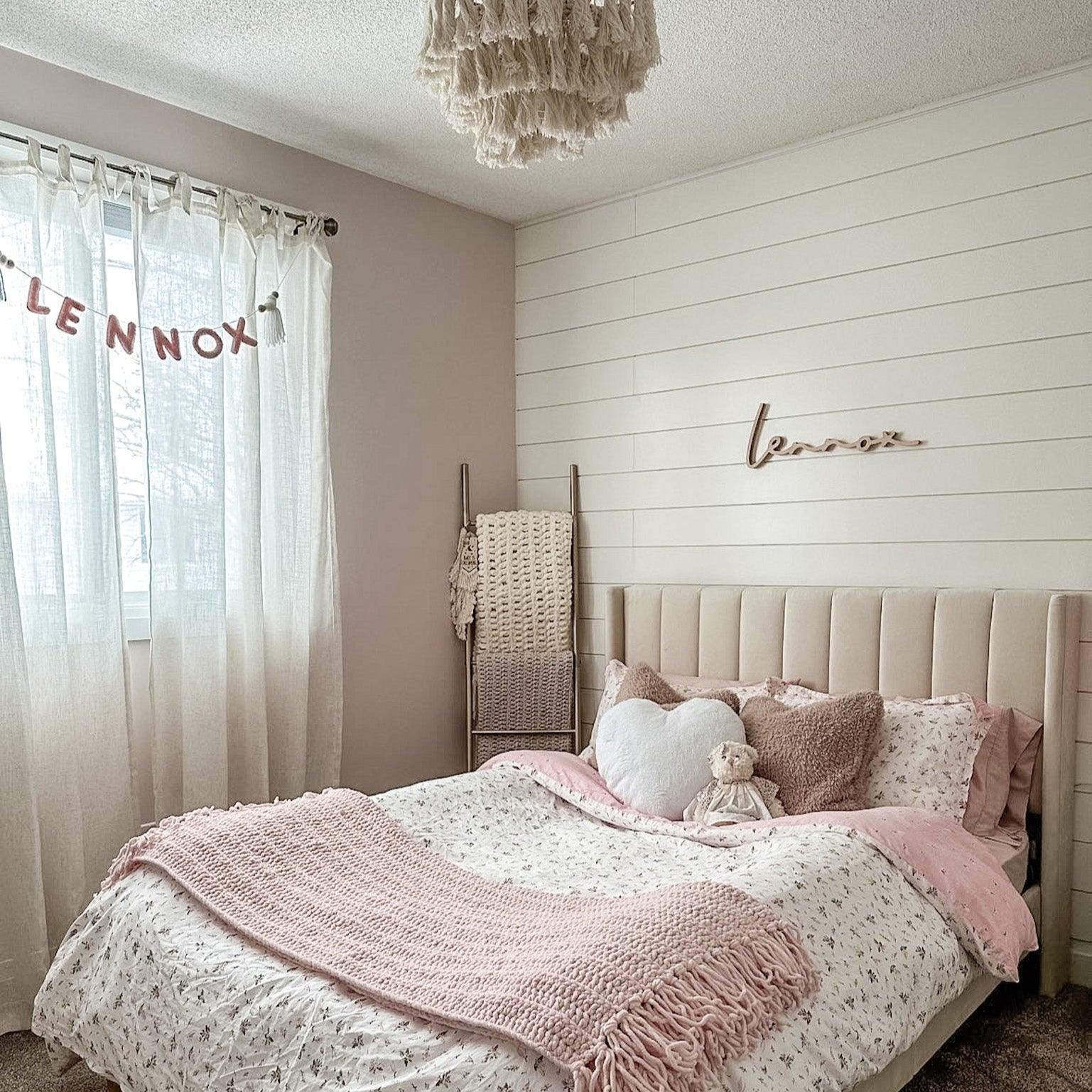 girl bedroom with name sign above bed