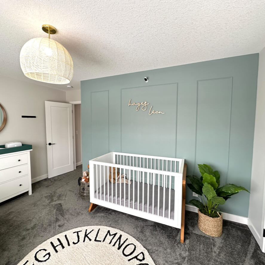 boy name sign on blue feature wall