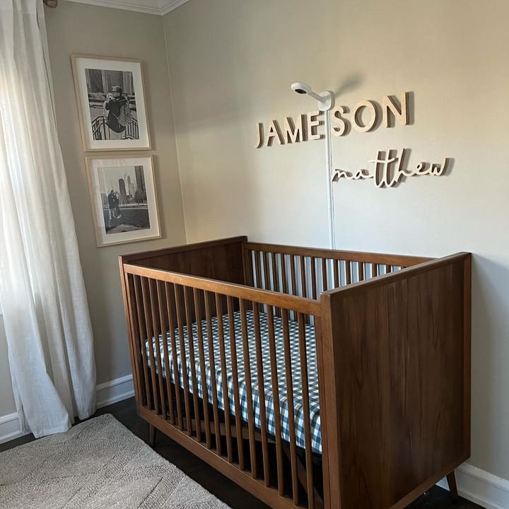 boy nursery name sign above crib