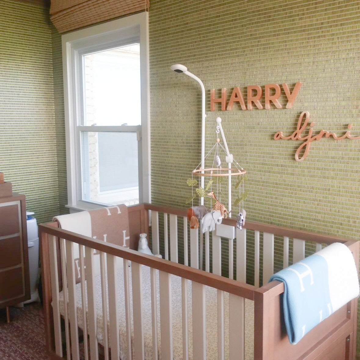 wooden name sign in boy nursery in wallpaper