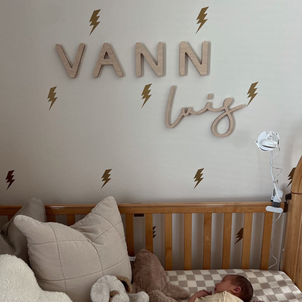 boy nursery with wooden name sign and lightning bolts