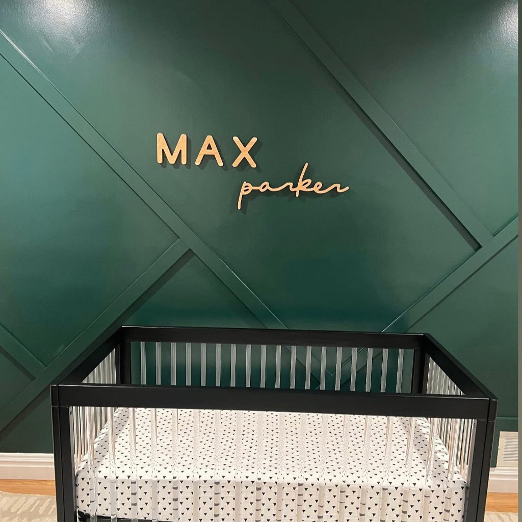 wooden name sign for boy in a green nursery