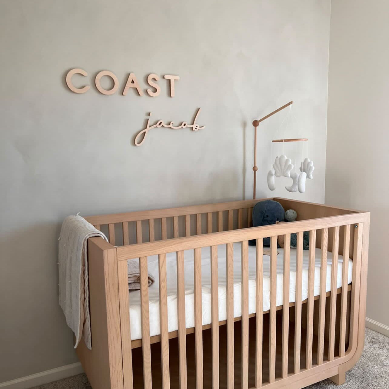 boy room with natural wooden elements and wooden name sign