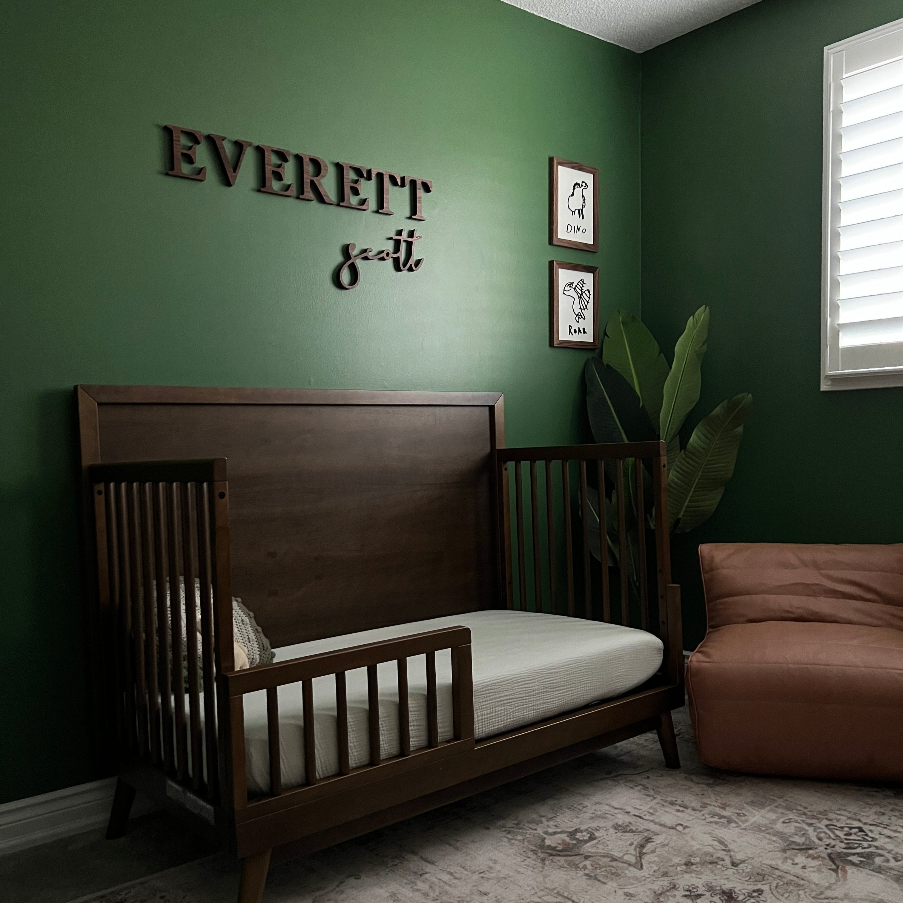 boy nursery with custom wooden sign in walnut