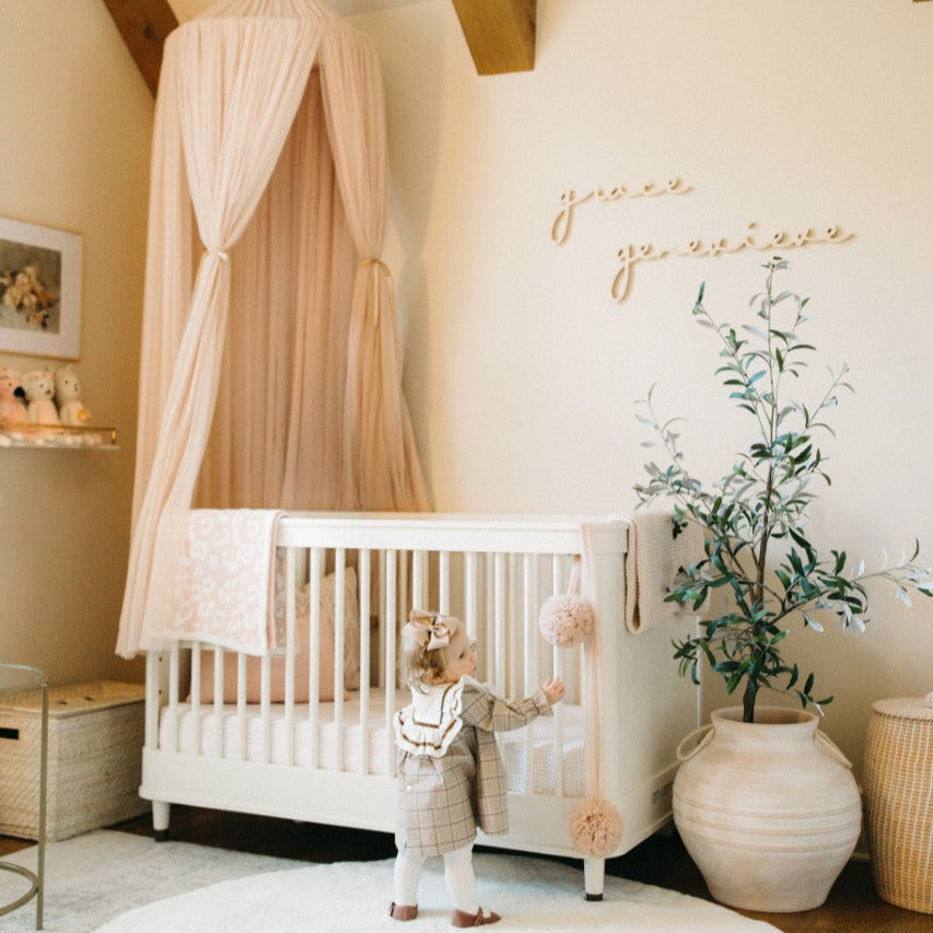 girl nursery design with wooden name sign