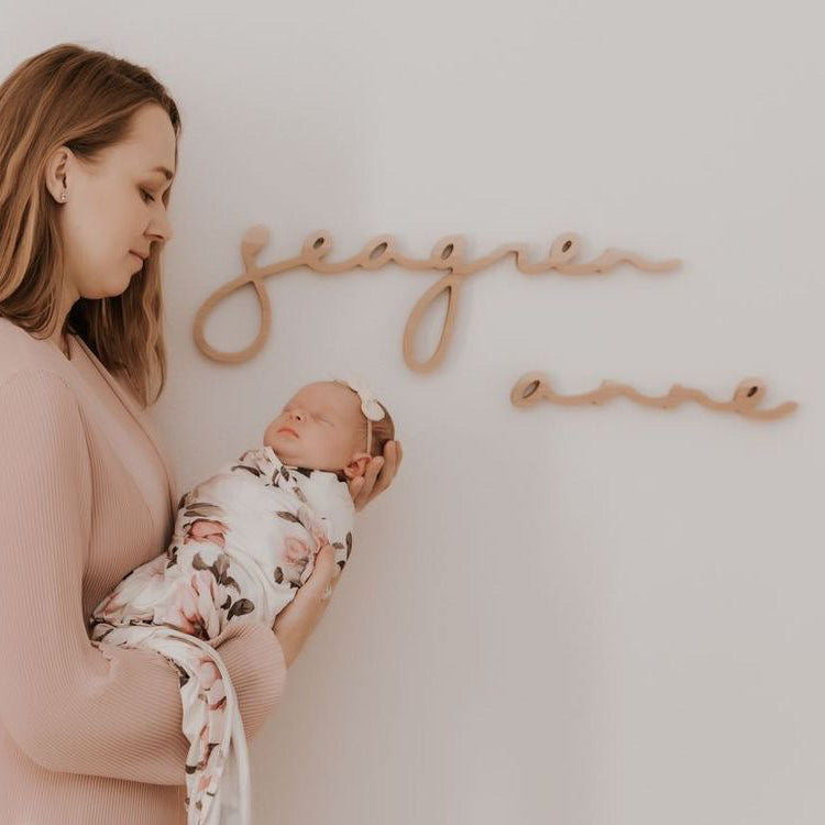 name sign on nursery wall during newborn photography