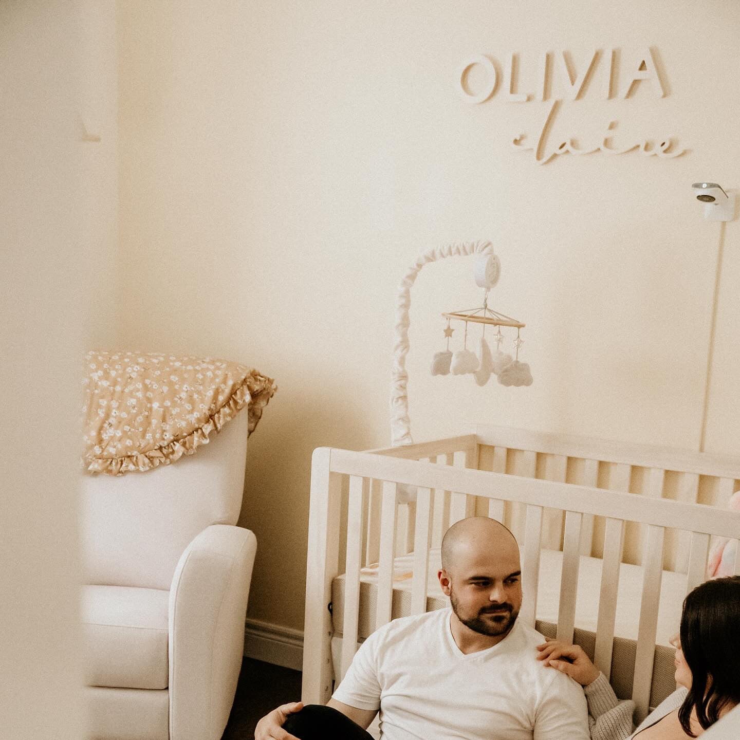 yellow nursery with wooden name sign